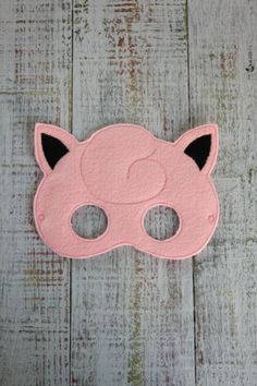 a pink mask with black ears and eyes