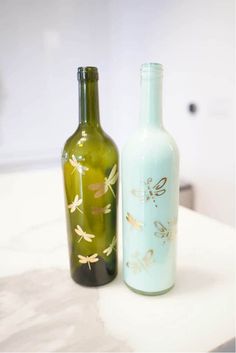 two glass bottles sitting on top of a counter