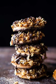 chocolate covered cookies stacked on top of each other with coconut flakes all over them