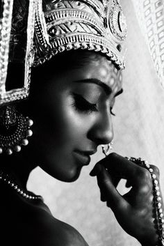 a black and white photo of a woman wearing a tiara