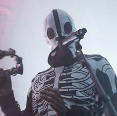 a man in skeleton costume holding a microphone