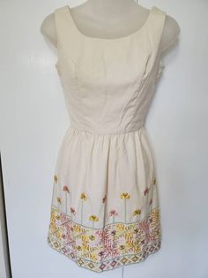 "Amazing vintage dress from the 70's! Vicky Vaughn Junior. Thick cream fabric. Beautiful geometric and floral embroidery! Zipper in the back. Mini Length. Cocktail Style. In Excellent Vintage Condition with no visible flaws. No size on tag, estimated size XS. Measurements: Bust: 32\" Waist: 24\" Hips: free Length: 32.5\"" Fitted Embroidered Off-white Dress, Fitted Embroidered Off White Dress, Fitted Off White Embroidered Dress, Cream Cotton Dress With Floral Embroidery, Fitted Cream Vintage Dress With Floral Print, Vintage Cream Dress For Spring, Vintage Cream Spring Dress, Cream A-line Cotton Dress, Fitted Beige Embroidered Dress With Floral Design