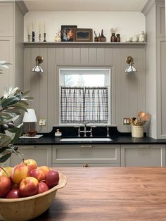 a bowl of fruit sitting on top of a kitchen counter