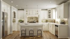 a large kitchen with white cabinets and wood floors