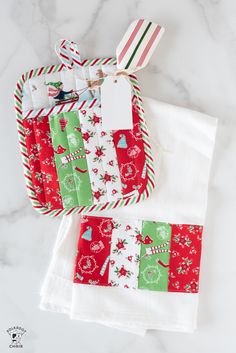 two christmas napkins on top of each other with candy canes in the middle