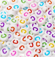 many white beads with multicolored letters on them