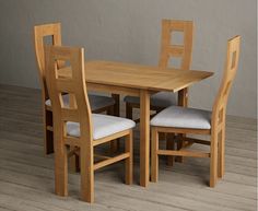 a wooden table with four chairs around it