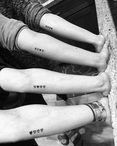 three people with matching tattoos on their arms