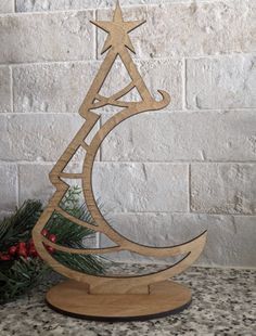 a wooden christmas tree on top of a table