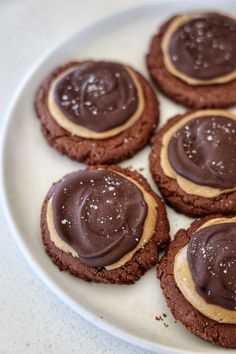 chocolate cookies with peanut butter frosting on a white plate