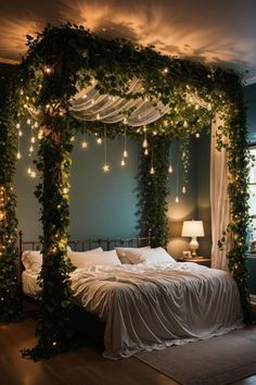 a bed covered in greenery with lights on the headboard and canopy over it