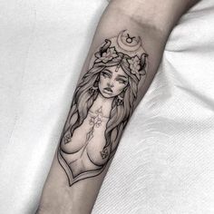 a woman's arm with a tattoo on it, and flowers in her hair