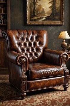 a brown leather chair sitting in front of a painting on the wall next to a lamp