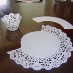 paper doily cut out to look like an ornament on a wooden table