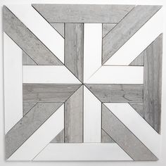 a white and grey tile design is shown in the middle of a square, diagonal pattern