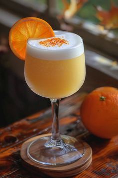 an orange and white drink sitting on top of a wooden table