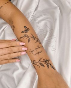 a woman's arm with flowers and butterflies on it, which reads you are my sunshine