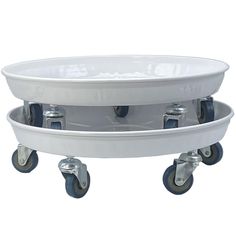 two white bowls sitting on top of each other with metal wheels and casters around them