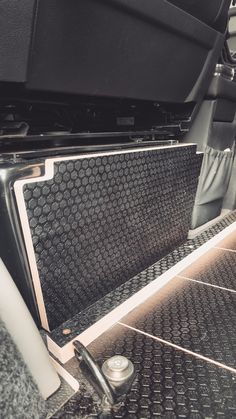 the inside of a vehicle with its door open and seat belt down, in black and white