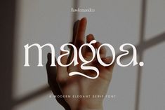 the word maggoa is written in white with a hand reaching up to it