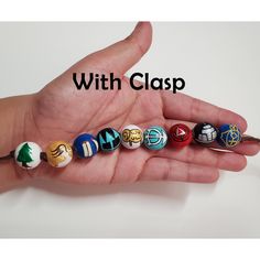 a hand holding an assortment of different colored balls with the words, with clasp