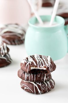 chocolate covered cookies with white icing on a table