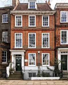 an old brick building with many windows and doors