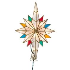 a colorful star shaped light hanging from a wire on a white wall next to a lamp bulb