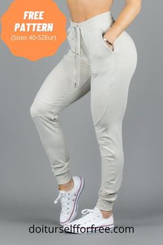 a woman in grey pants and white top posing with her hands on her hips,