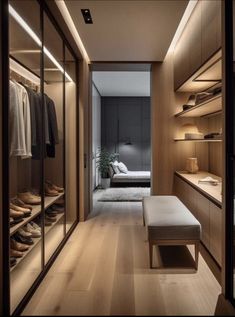 a walk - in closet with wooden shelves and shoes on the floor, along with a bench