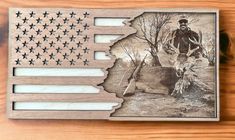 an american flag with a man standing next to it on top of a wooden table