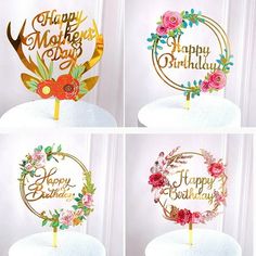 four birthday cake toppers with flowers on them