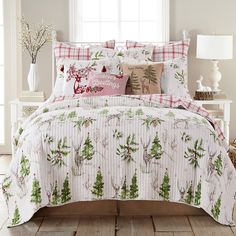 a bed with christmas themed comforters and pillows