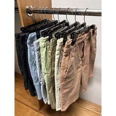 four pairs of pants hanging on a rail