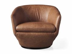 a brown leather chair sitting on top of a white floor