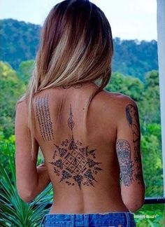 a woman with tattoos on her back