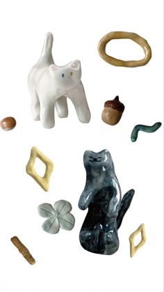 several ceramic objects are arranged in the shape of animals and shapes that appear to be handmade