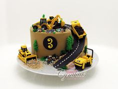 there is a cake that looks like a construction site on top of a plate with tractors