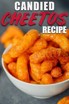 a white bowl filled with cheetos sitting on top of a table