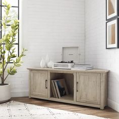 a living room with white brick walls and wooden furniture