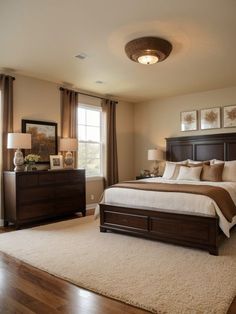 a bedroom with a bed, dressers and lamps in it's center area