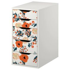 a white cabinet with orange and blue flowers painted on the front, drawers are closed