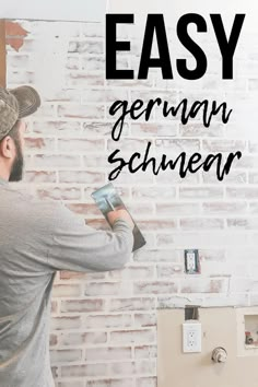 a man is painting a brick wall with the words easy german schnemer