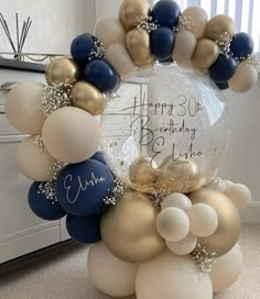 a birthday balloon arch with balloons and confetti on it in the shape of a wreath