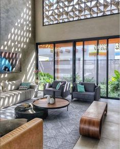 a living room filled with furniture and lots of windows