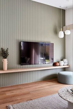 a flat screen tv mounted to the side of a wall