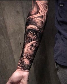 a man's arm with a tattoo on it and an image of a monkey