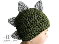 a crocheted hat with ears on top of a mannequin's head