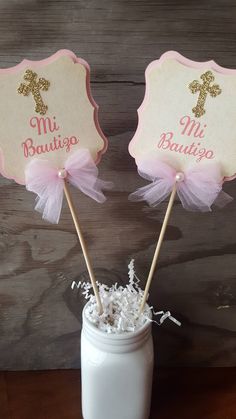 two pink and gold cupcake toppers in a mason jar