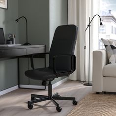 a black office chair sitting in front of a desk